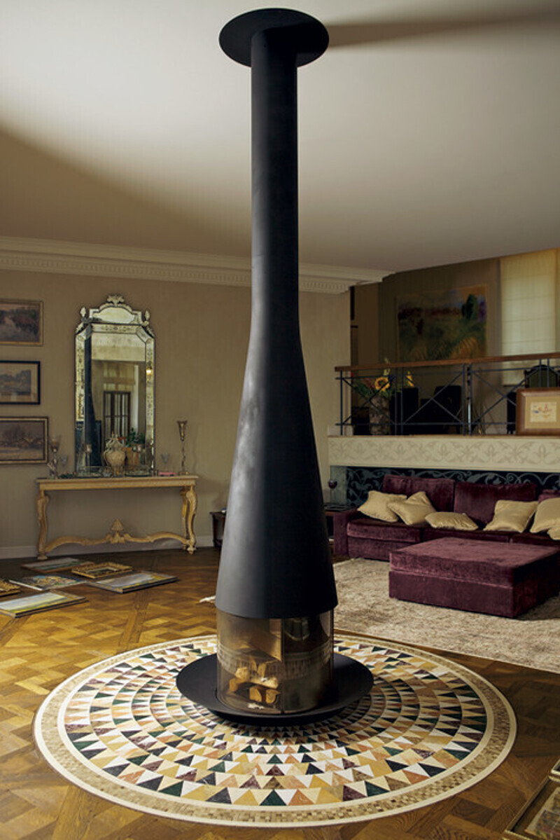 Черный камин расположился прямо посреди гостиной. Когда его зажигают, он согревает всю комнату. Фото: Сергей Козловский.